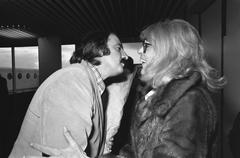 Melina Mercouri arriving at Schiphol Airport greeted by Andre van der Louw on October 25, 1974 black and white photo