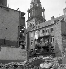 Black and white photograph of demolition of a church building with visible wooden framework and debris in Amsterdam