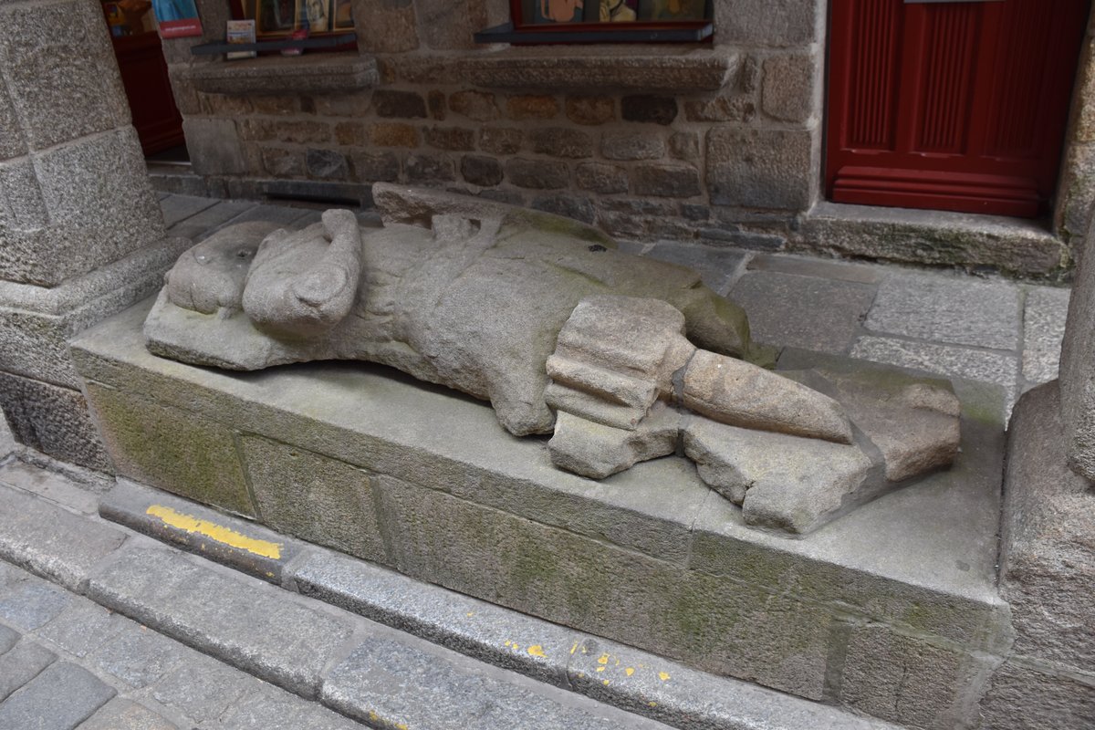 Gisant statue in Dinan depicting a reclining figure in medieval attire