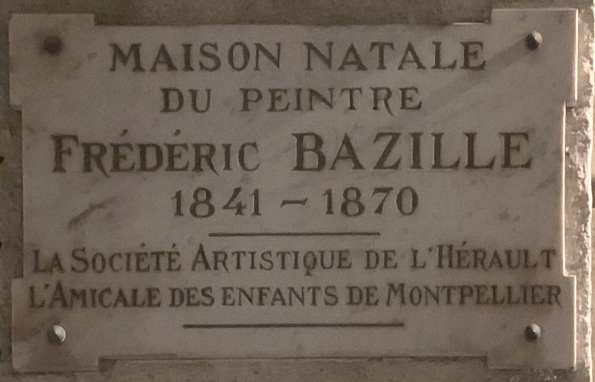 Plaque commemorative at the birthplace of Frédéric Bazille in Montpellier at night