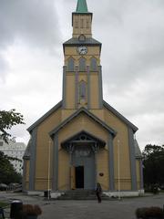 Church in Tromsö town with wooden architecture and mountainous background