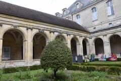 Cloister of Saint Martin Abbey in Laon, historic stone arches and wooden ceiling