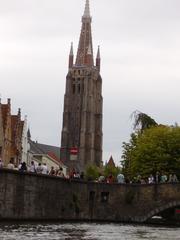 Canal in Bruges with historic buildings and boats during summer