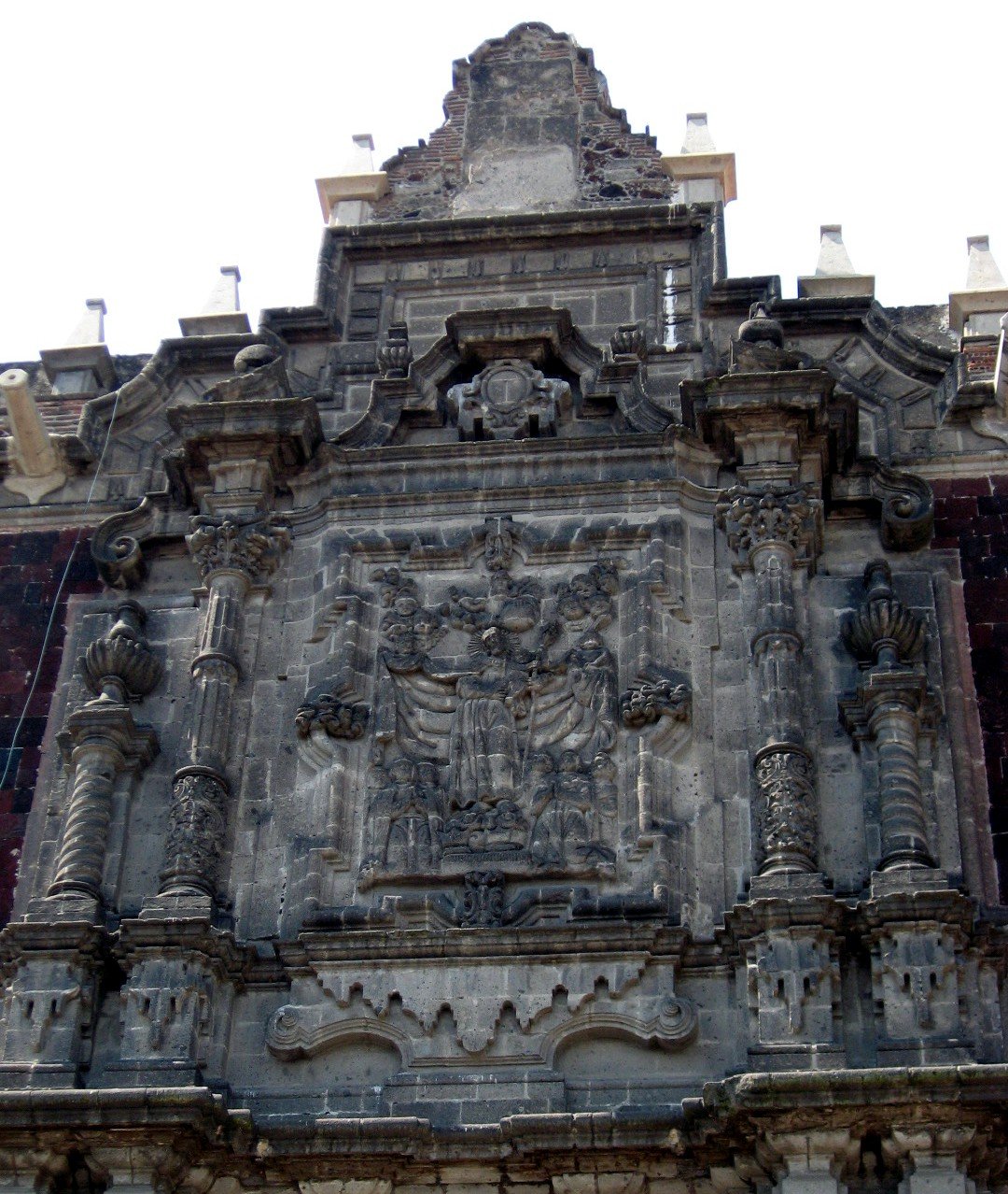 Upper baroque portal detail with intricate reliefs at Colegio Chico, San Ildefonso College, Mexico City