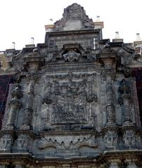 Upper baroque portal detail with intricate reliefs at Colegio Chico, San Ildefonso College, Mexico City