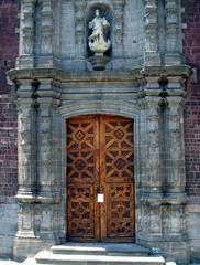 Lower portion of historic Colegio Chico portal with wooden doors at San Ildefonso College in Mexico City