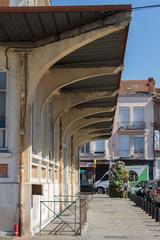 Marché de Villebourbon outdoor market with people shopping and colorful market stalls