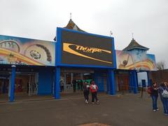 Entrance to Thorpe Park amusement park with signage and vibrant landscaping