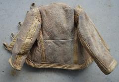 Miniature jacket made from rabbit fur, labeled Kailis Wilna, from a fur factory in Vilnius during WWII