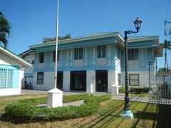 Facade of Baldomero Aguinaldo Shrine Museum with fences and tombs in Kawit, Cavite