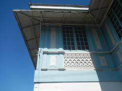 Facade of Museo ni Baldomero Aguinaldo y Baloy with fences and interior featuring tombs of Baldomero and Petrona Reyes in Binakayan, Kawit, Cavite