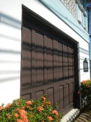 Facade of Baldomero Aguinaldo Shrine museum with fences and tombs of Baldomero and Petrona Reyes in Binakayan, Kawit, Cavite