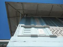 Facade of the Baldomero Aguinaldo Shrine museum with fences and tombs of Baldomero and Petrona Reyes in Binakayan, Kawit, Cavite