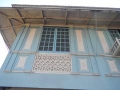 Facade and interior of Baldomero Aguinaldo Shrine museum with fences and tombs of Baldomero and Petrona Reyes in Kawit, Cavite