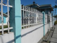 Facade of Baldomero Aguinaldo Shrine museum with fences and visible tombs in Binakayan, Kawit, Cavite