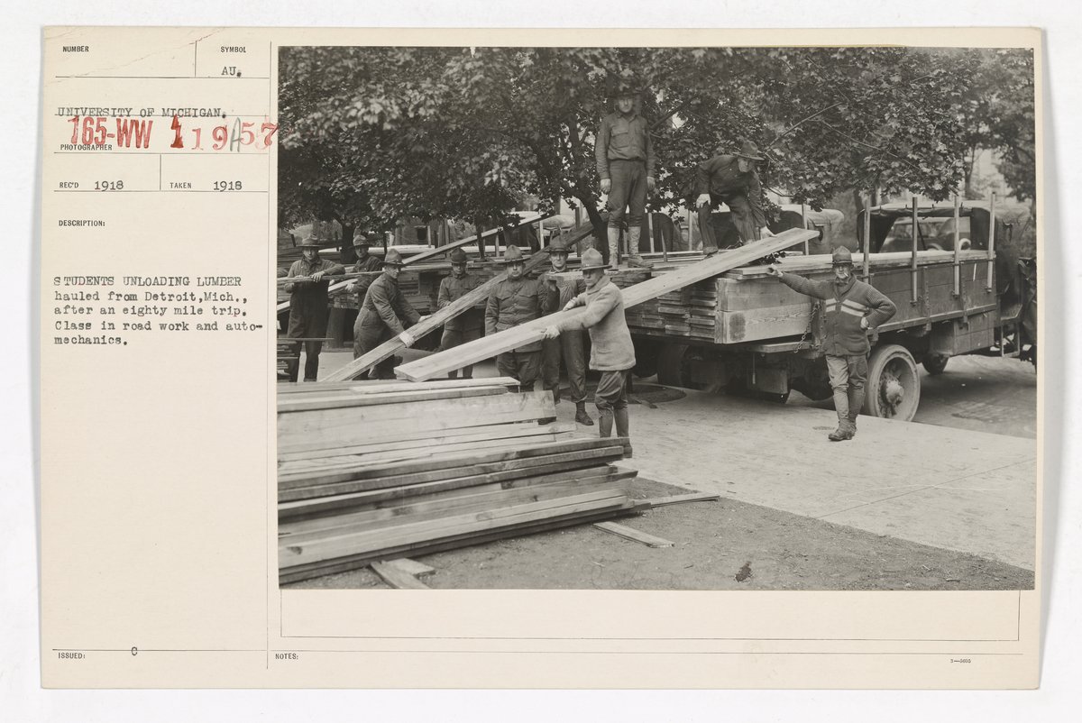 University of Michigan Student Army Training Corps unloading lumber from Detroit for road work and auto mechanics class