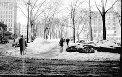 Pedestrians crossing Victoria Square in Montreal during rush hour