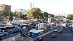 Construction site of Shaul Hamelech Light Rail Station in Tel Aviv with machinery and workers