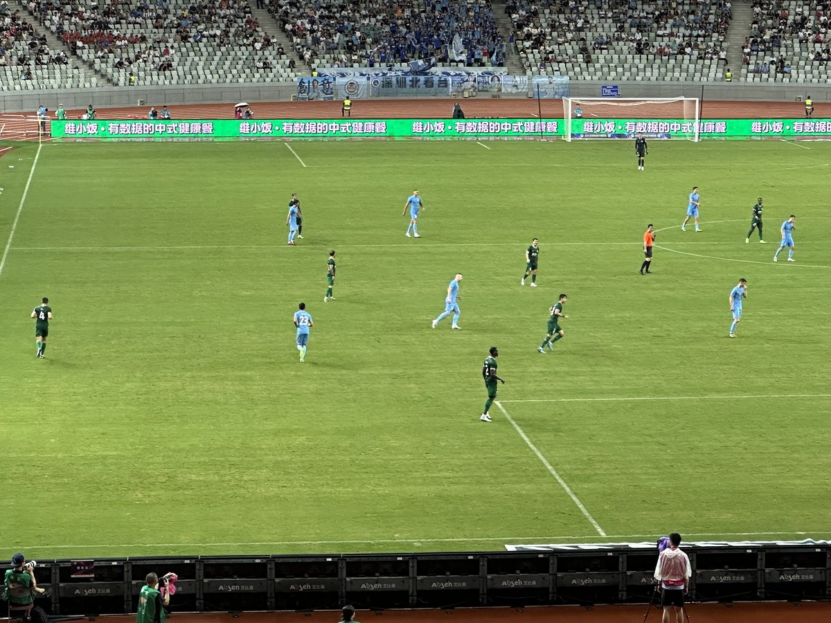 Shenzhen Peng City players competing against Beijing Guoan in a Chinese Super League football match on 26 July 2024