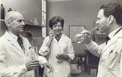 Dr. Luis Federico Leloir celebrating Nobel Prize in Chemistry with champagne in a laboratory tube in 1970