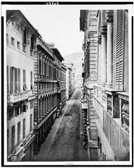 Historic black and white street view of Genova's Strada Nuora with pedestrians and buildings