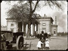 View of Haarlemmerpoort with houses in the background at Nassauplein, featuring D. Eskens with his two sons in front of J. Eskens & Zoon painting company at Haarlemmerplein 14, Amsterdam, 1894
