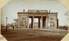 Historic view of Haarlemmerplein in Amsterdam featuring the Willemspoort gate and partially visible Willemspoort railway station around 1868