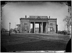 Historic Haarlemmerpoort gate with old Willemspoort station visible behind, circa 1868