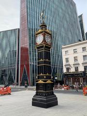 Little Ben clock tower in London under a cloudy sky