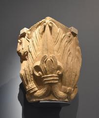 Fragment of a carved stone capital at Musée Saint Rémi in Reims, showcasing detailed medieval architecture