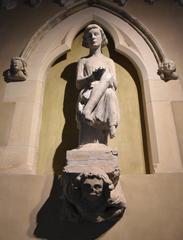 Statue of a jester playing bells at Musée Saint Rémi in Reims