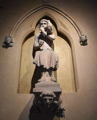 Ancient statue of a pipe player at Musée Saint Rémi in Reims