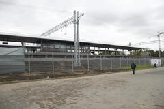 Exterior view of Botanichesky Sad MCC station with train on elevated tracks