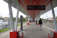 Rostokino MCC station platform with yellow train and passengers