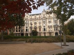 House near Parque del Oeste seen through vibrant red foliage in Madrid