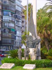 View of Alicante Plaza Puerta del Mar square with palm trees, benches and surrounding buildings