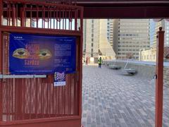 Sign announcing art show at Chinese Culture Center of San Francisco on pedestrian bridge gate