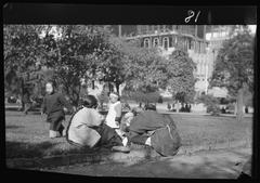 A picnic on Portsmouth Square in Chinatown, San Francisco with people gathered and enjoying food