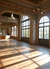 Elegant ballroom of the Trianon with ornate chandeliers and classic decor