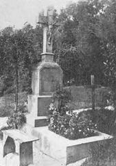 Grave of Stanisław Reichenberg in a cemetery with a stone cross and flowers