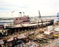USNS Andrew J. Higgins fleet oiler under construction at Avondale shipyard with USS Wisconsin battleship in background
