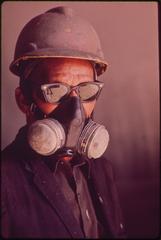 Spray painter wearing respiratory protection mask at Avondale Shipyard