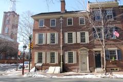 Colonial brick boarding house with St. Peter's church spire in background