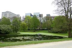 Leopold Park in Brussels with lush greenery and a serene pond