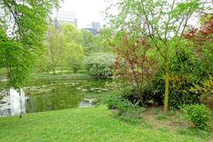 Leopold Park in Brussels Belgium with trees and walkways under a blue sky