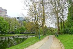 Leopold Park with lush green trees and pathways in Brussels, Belgium