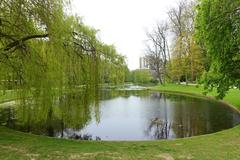 Leopold Park in Brussels, Belgium with lush green trees and a calm pond