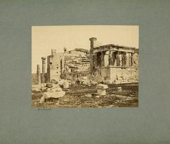 Southwest view of Erechtheion with marble caryatids and a seated man on a stone