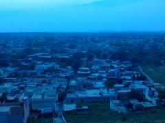 Scenic view of Jhansi city from a hilltop with buildings and greenery under a clear sky