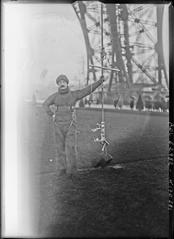 Historical image showing inventor M. Paul using 'ouistiti' device on Eiffel Tower in Paris, 1921